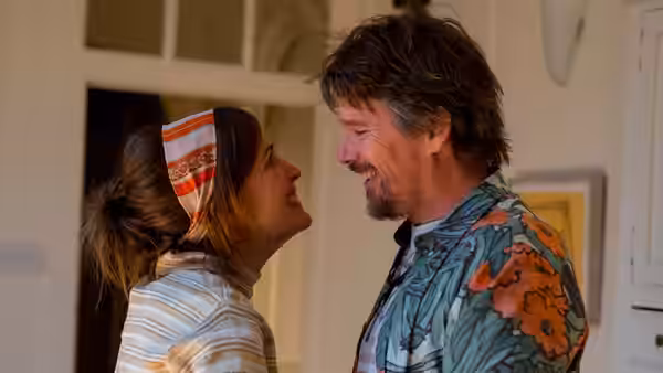 Annie Platt (Rose Byrne) and Tucker Crowe (Ethan Hawke) smile at each other indoors