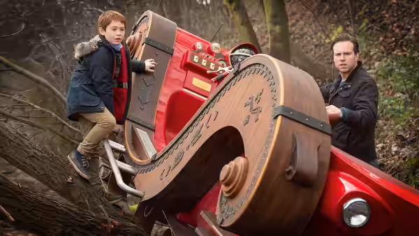 Tom (Kit Connor) and Steve (Rafe Spall) climb aboard a red flying vehicle