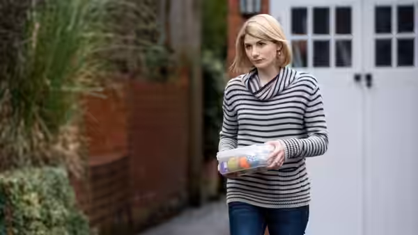 Alison (Jodie Whittaker) carries a box outside a building