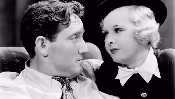Danny Dolan (Spencer Tracy) turns toward Helen Riley (Joan Bennett) seated beside him