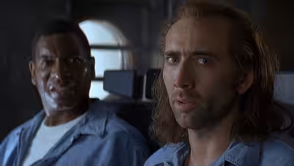Cameron Poe (Nicolas Cage) sits beside Baby-O O'Dell (Mykelti Williamson) aboard the plane