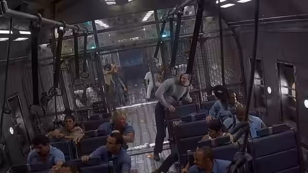 Inmates sit among rows of blue seats inside the crowded prison transport aircraft