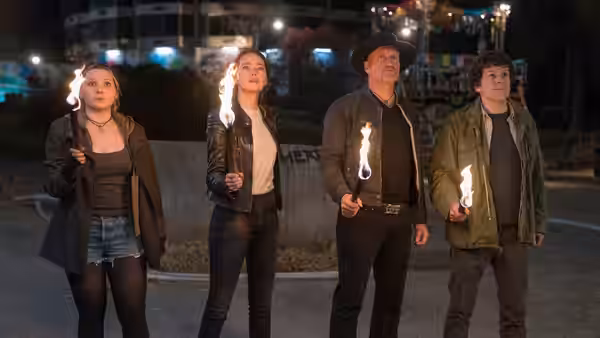 Madison, Wichita, Tallahassee and Columbus hold candles outside at night