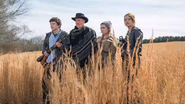 Columbus and Tallahassee stand armed with two women in a golden field