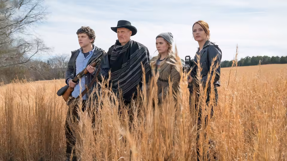 Columbus and Tallahassee stand armed with two women in a golden field