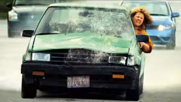 Tammy leans out of a car window in traffic
