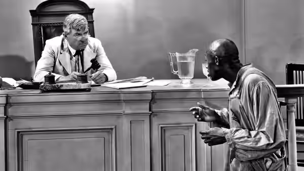 Judge William Pitman 'Billy' Priest (Will Rogers) listens as a man addresses him at the bench