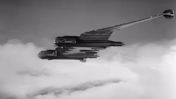 A streamlined aircraft flies above a layer of clouds