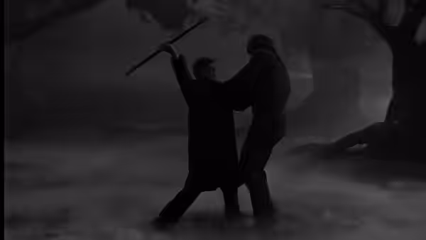 A man raises a stick as he struggles with a figure in the mist