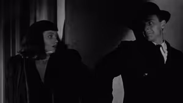 Jacqueline Gibson looks toward Dr. Louis Judd in a dark doorway