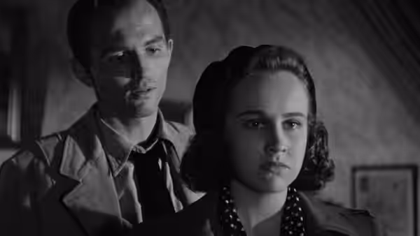 Mary Gibson (Kim Hunter) stands in front of Gregory Ward (Hugh Beaumont)