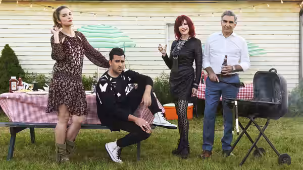 Alexis Rose (Annie Murphy) David Rose (Dan Levy) Moira Rose (Catherine O'Hara) and Johnny Rose (Eugene Levy) at a backyard barbecue