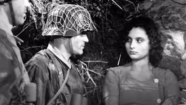 An American soldier in a netted helmet faces a young woman inside a shelter