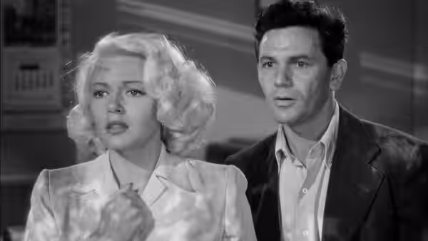 Cora Smith (Lana Turner) and Frank Chambers (John Garfield) stand side by side indoors