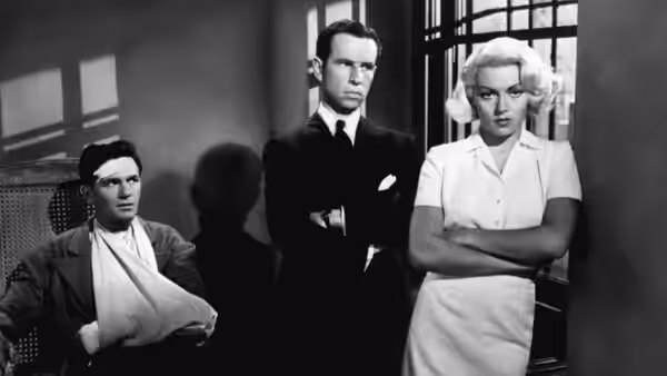 Frank Chambers (John Garfield) sits with his arm in a sling as Cora Smith (Lana Turner) stands nearby