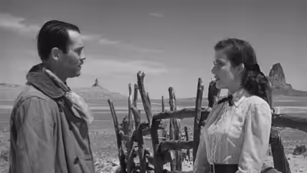 Wyatt Earp (Henry Fonda) and Clementine Carter (Cathy Downs) face each other beside a desert corral