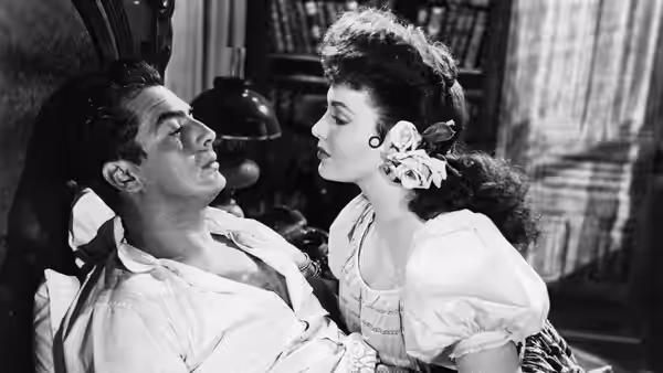 Doc Holliday (Victor Mature) reclines as Chihuahua (Linda Darnell) leans close beside him