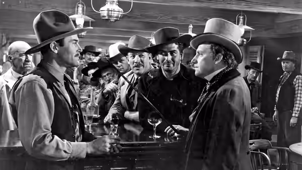 Wyatt Earp (Henry Fonda) faces Doc Holliday (Victor Mature) across a crowded saloon