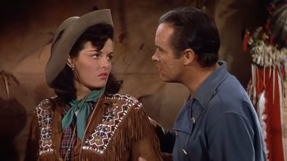 Calamity Jane (Jane Russell) faces Peter Potter (Bob Hope) in a Western outfit and fringed jacket