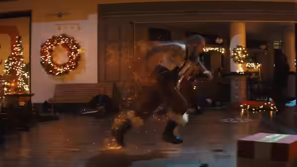 A figure runs past a lit Christmas wreath and festive decorations