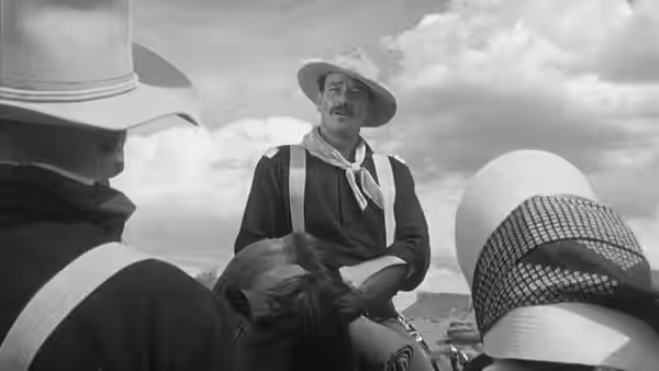 Kirby Yorke (John Wayne) sits on horseback among soldiers