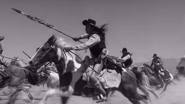 Mounted soldiers charge across the field with rifles and lances