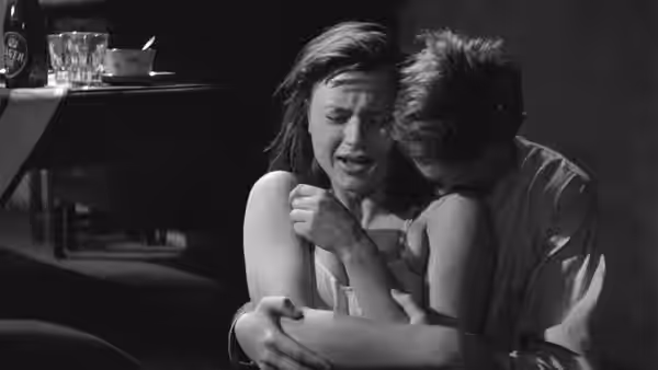 Harry (Lars Ekborg) holds Monika (Harriet Andersson) as she cries indoors