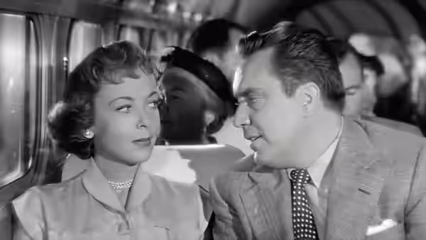 Eve Graham (Joan Fontaine) and Harry Graham (Edmond O'Brien) sit together on a bus