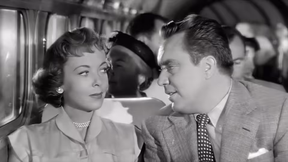 Eve Graham (Joan Fontaine) and Harry Graham (Edmond O'Brien) sit together on a bus