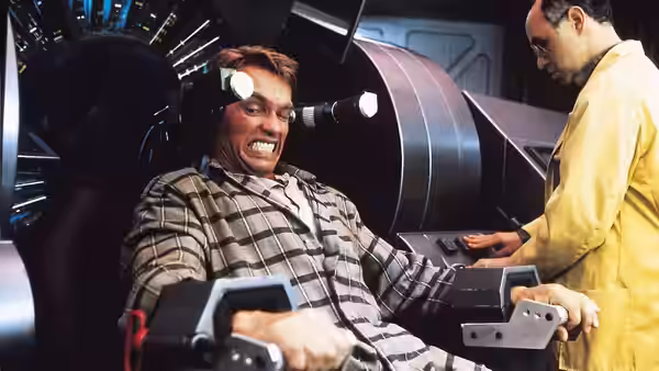 Quaid (Arnold Schwarzenegger) strapped into a memory implant chair beside a technician