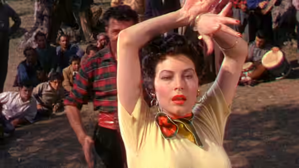 Maria Vargas (Ava Gardner) dances with her arms raised as men watch nearby