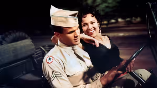 Joe (Harry Belafonte) drives while Carmen (Dorothy Dandridge) leans close beside him