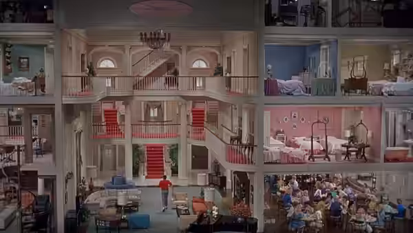 A tiny figure stands inside a sprawling multi-storey house filled with rooms and balconies
