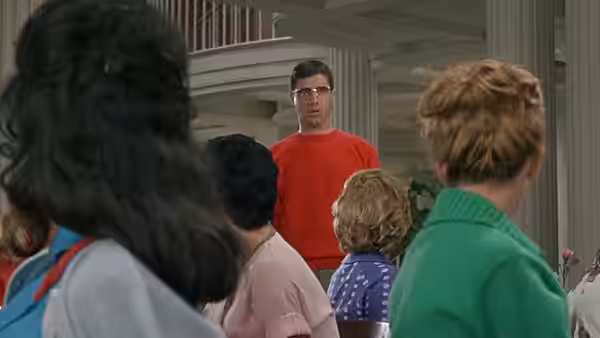 Herbert H. Heebert (Jerry Lewis) faces a group of women inside a multi-storey house
