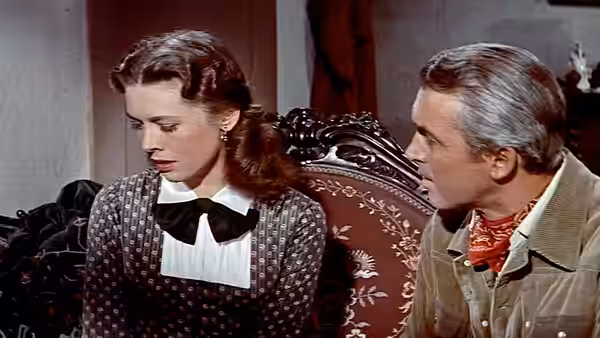Barbara Waggoman (Cathy O'Donnell) looks down beside Alec Waggoman in a parlor