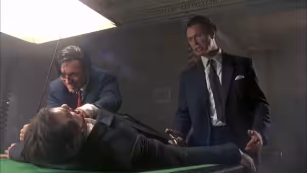 Reggie Kray (Martin Kemp) restraining a man on a pool table as another watches