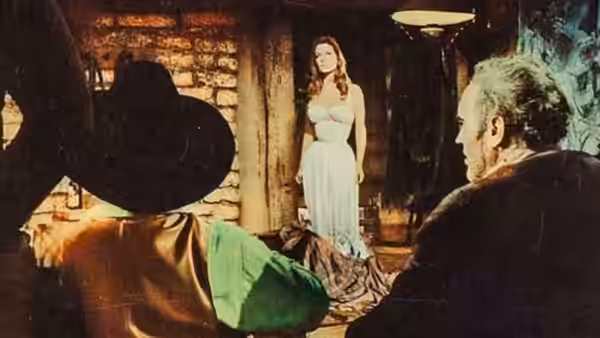 A woman stands in a doorway as several men sit inside a dimly lit room