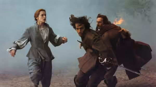 Roxane (Anne Brochet) running beside Cyrano (Gérard Depardieu) with a sword