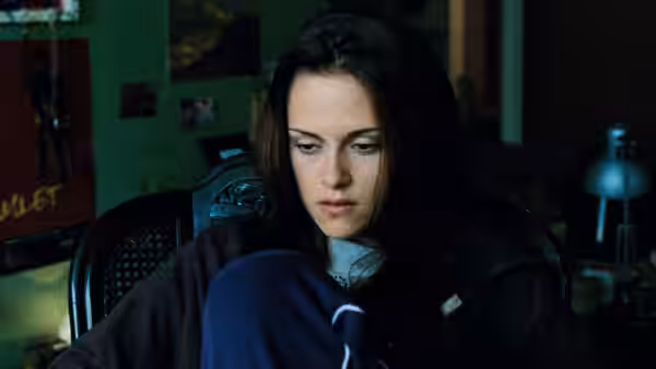 Bella Swan (Kristen Stewart) sits hunched in a dark bedroom
