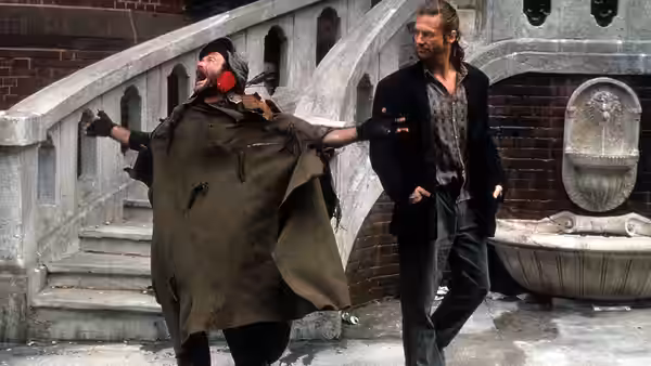 Parry (Robin Williams) dances with arms out beside Jack (Jeff Bridges)