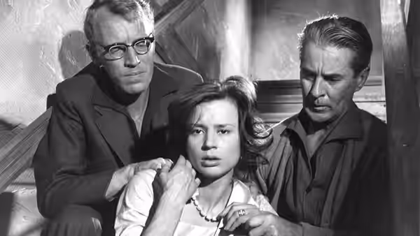 Karin (Harriet Andersson) sits between David (Gunnar Björnstrand) and Martin (Max von Sydow)