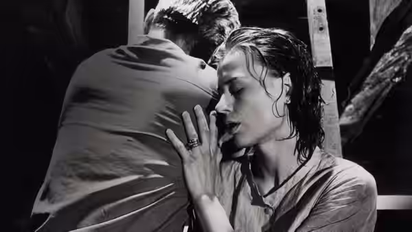 Karin (Harriet Andersson) embraces a man indoors