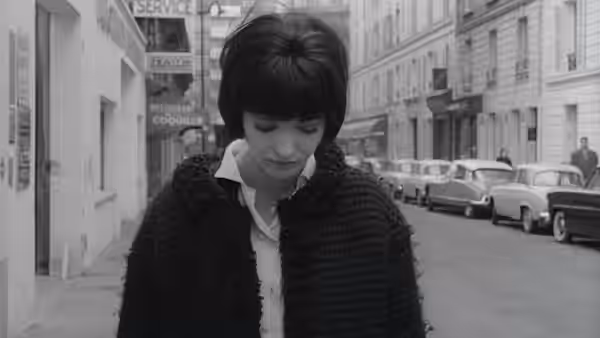 Nana Kleinfrankenheim (Anna Karina) looks down on a city street