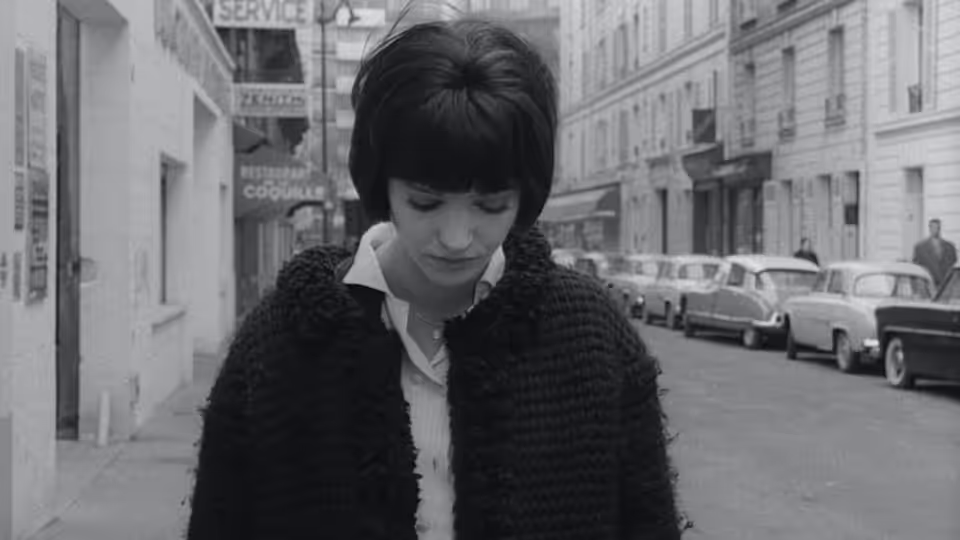 Nana Kleinfrankenheim (Anna Karina) looks down on a city street