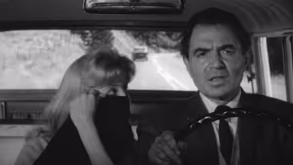 Humbert Humbert (James Mason) drives with Lolita (Sue Lyon) beside him