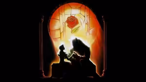 Belle and the Beast silhouetted before a glowing enchanted rose
