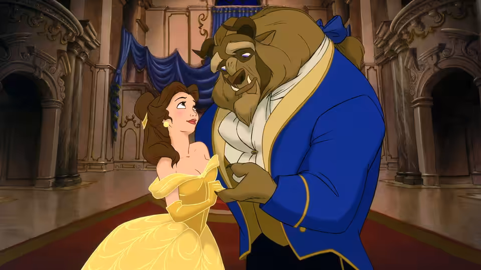 Belle and the Beast holding hands closely in a grand ballroom