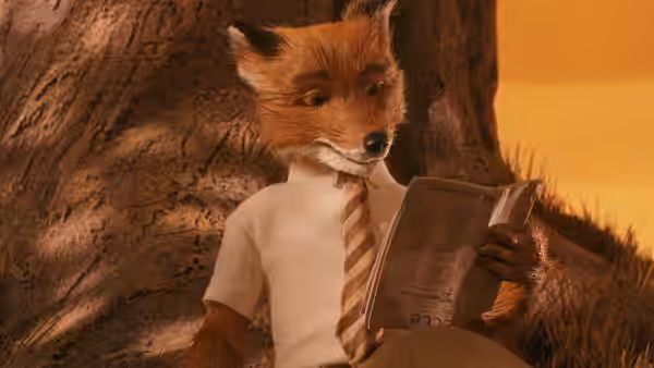 A fox in a shirt and striped tie reads an open newspaper while seated under a tree