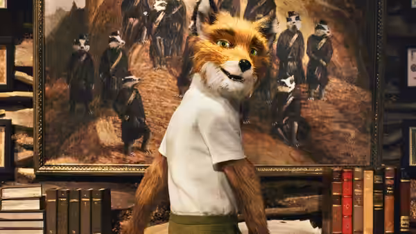 A fox in a white t-shirt stands before a large painting of badgers on a wall