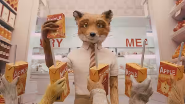 An orange fox in a shirt holds an apple juice box above reaching paws in a supermarket